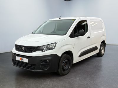 the white van is parked in a large room with a black floor