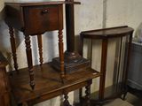 a small table with a lamp on top of it next to a chair