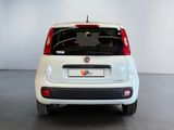 a small white car that is parked in a room