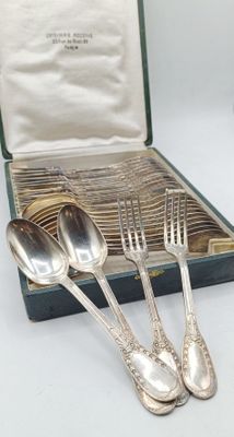 three silver spoons and two silver spoons in a case