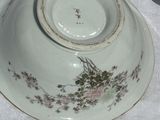 a bowl and plate on a table with a white table cloth