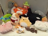 many stuffed animals sitting on a white table
