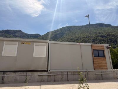 a picture of a building with a mountain in the background