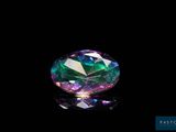 un gros plan d'un diamant coloré sur une surface noire