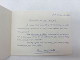an open book with a handwritten letter on it sitting on top of a table