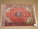 a red rug with a medallion design on it