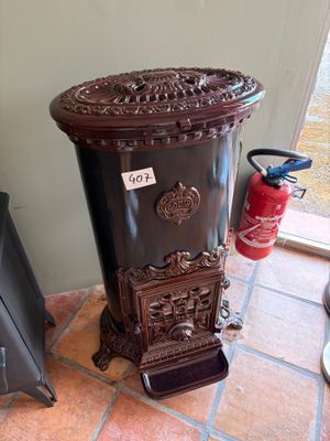 a black fire hydrant sitting on the floor next to a fire hydrant