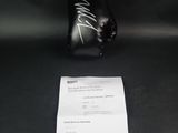 signed boxing gloves and receipt on a black table