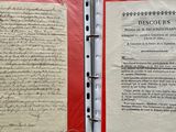 two pages of paper with writing on them in a binder