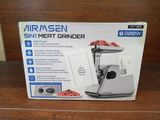 an image of a box of meat grinder sitting on top of a wooden table