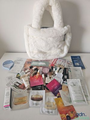 a white purse sitting on top of a white table