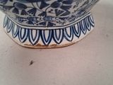 a blue and white bowl sitting on top of a table