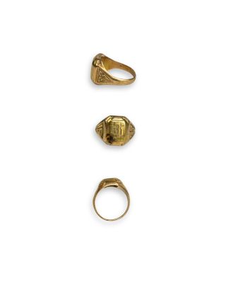 three gold rings and a ring with a lion head on it
