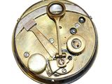 a close up of a clock that is on a white surface