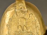a gold helmet with an eagle on it