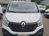 the front view of a white van parked in a parking lot