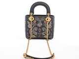 a black and gold purse with a chain handle