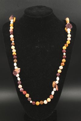un collier composé de perles multicolores sur un mannequin noir
