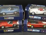 three toy cars are sitting in boxes on a black surface