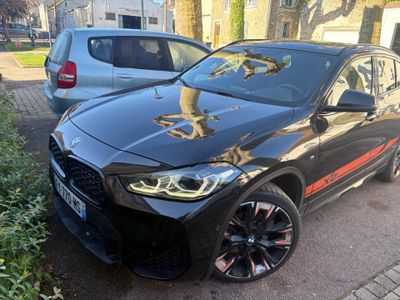 a black bmw suv parked on the side of the road