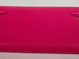 a pink purse on a white surface