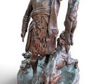 bronze statue of a man with a dog and a duck