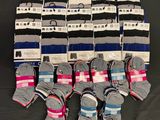 several pairs of men ' s socks are stacked on a black surface