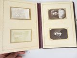 a person holding a book with pictures in it