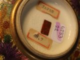 a close up of a vase with a tag on it