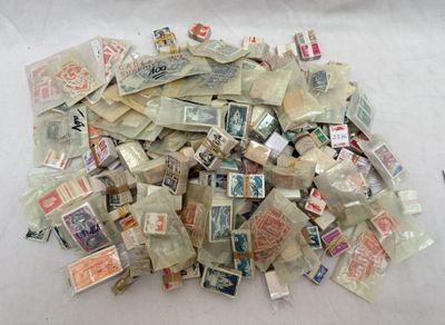 a pile of old postage stamps on a table