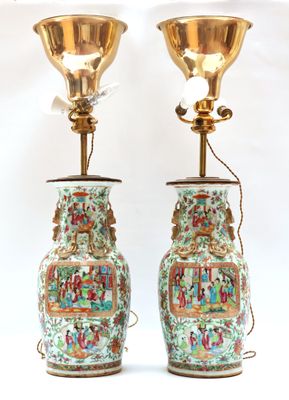 pair of chinese vases with asian scenes on them on a white background