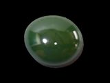 a picture of a green jade ball on a black background