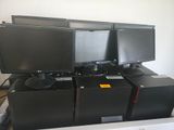 several computer monitors are stacked on top of each other in a room