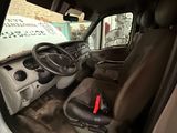 a white van with a steering wheel and a dashboard