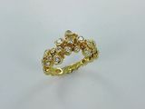 gros plan d'une bague en or et diamants sur une surface blanche