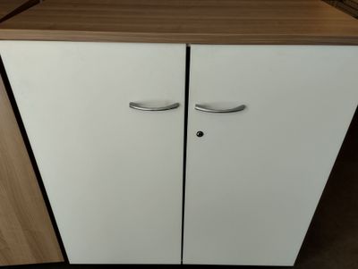 a white cabinet with two doors and a wooden top