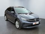 the grey volkswagen suv is parked in a room with a white wall