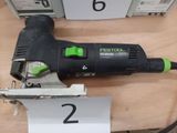 a black and green electric sander on a table