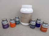 six bottles of vitamins and one jar of vitamin
