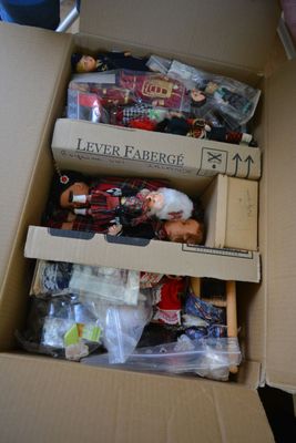 a cardboard box filled with toys and other items