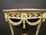 a table with a marble top and gold decoration