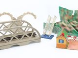 a small model of a bridge and a small model of a house