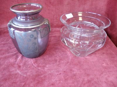 two glass vases sitting on a pink cloth