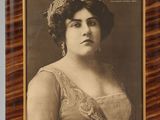 an old photo of a woman in a dress and tiable