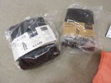 two pairs of underwear wrapped in plastic bags on the floor