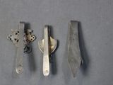 three different types of scissors and a knife on a table