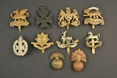 some of the badges are gold and silver on a black background