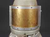 an egg with a helmet on it sitting on a pedestal