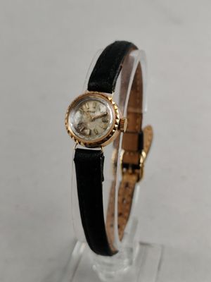 a close up of a wrist watch on a clear surface