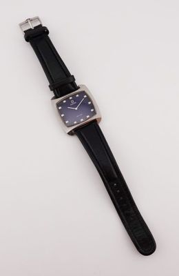 gros plan d'une montre sur une surface blanche avec un bracelet noir
